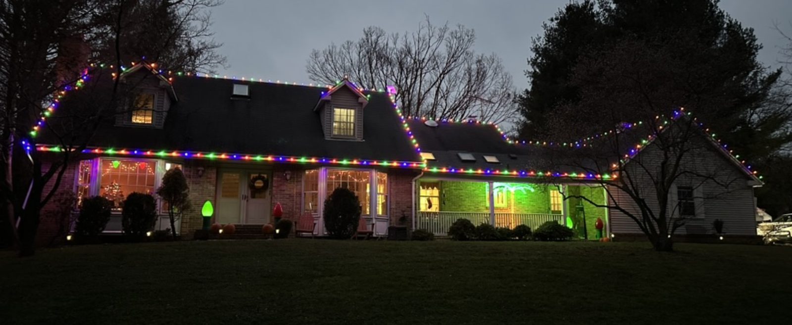 Custom Christmas roofline lighting on a Maryland home