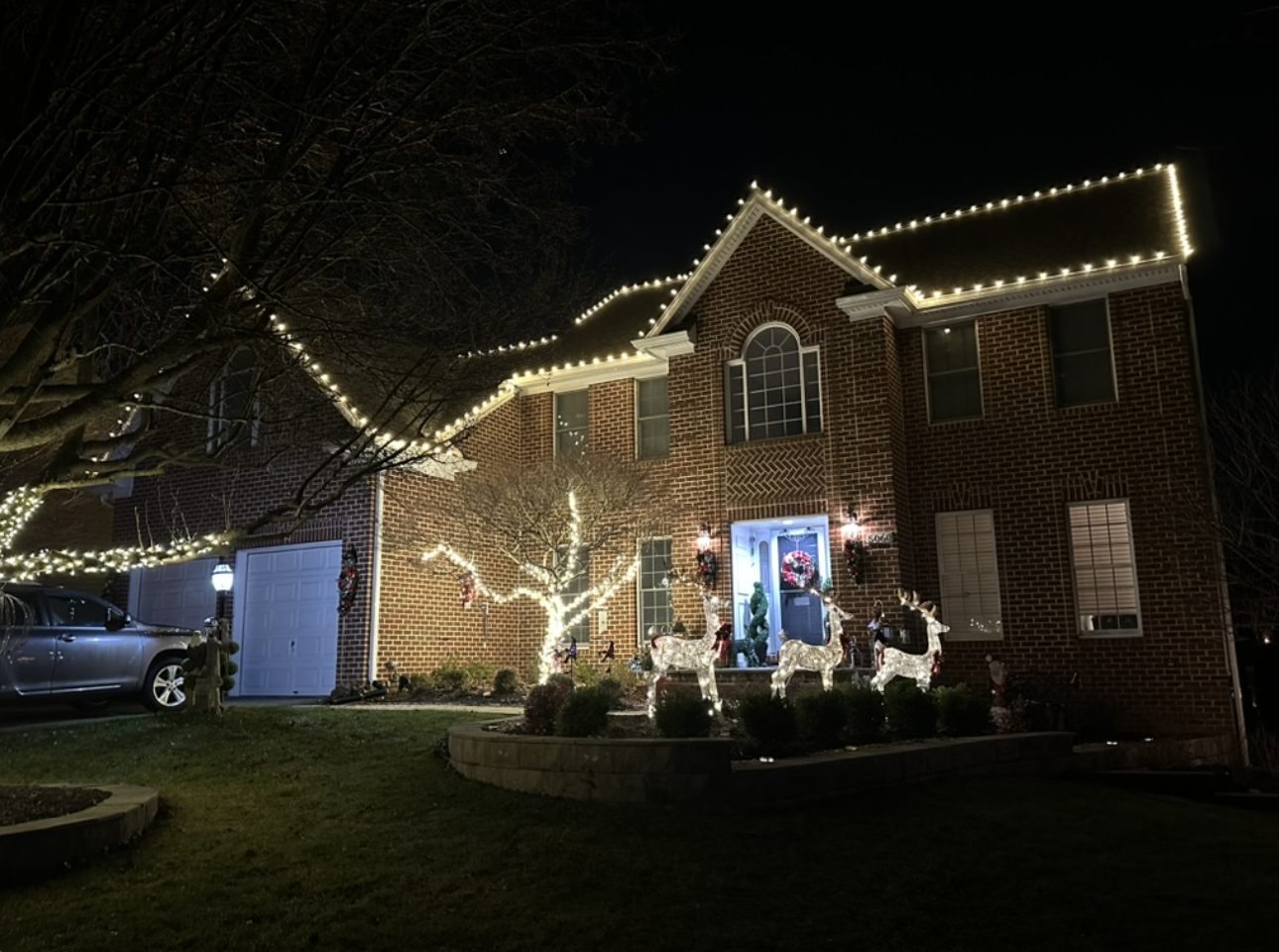 Christmas roofline lighting on a two-story brick home